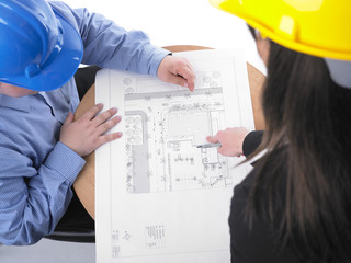 Two architects with hard hat and plan on meeting