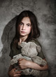 Leinwanddruck Bild - Sad little girl with toy