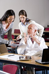 Wall Mural - Scientist talking to assistants in conference room