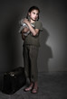 Leinwanddruck Bild - Little lonely girl with suitcase