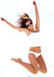 © get4net - Young woman jumping on the beach