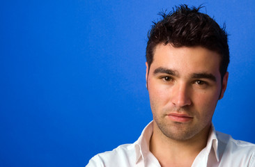 Young casual atractive man, on a blue background