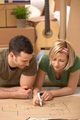 Canvas Print - Young couple planning their new home