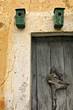 Two green nest boxes above an old door near the city of Vilafran