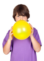 Wall Mural - Funny boy blowing up a yellow balloon