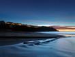 Luxury homes overlook the California coast at sunset