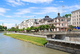 Fototapeta Paryż - Elegant buildings line the Salzach River, downtown Salzburg