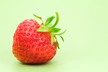 red fresh strawberry, isolated on green background