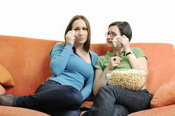 two woman watching television