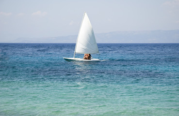 white sailing boat on turquoise ionian sea