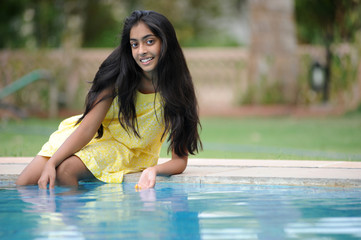 girl sitting at pool