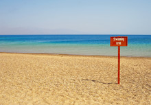 View From A Tropical Beach With Swimming Sign