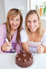 Wall Mural - Happy friends with a cake smiling at the camera