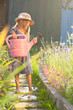 Gardening. Girl with watering can.