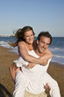 © veneratio - Young Attractive Couple Playing on Beach