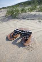 Abandoned Slippers On The Beach
