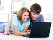 © Valua Vitaly - Smiling couple looking at laptop