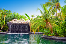 Maldives. Pool With Small Fall In Tropical Garden.
