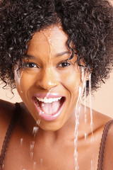 Cute African American with water dripping through her face