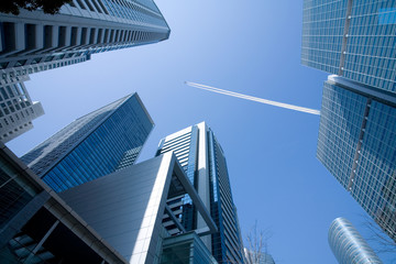 Wall Mural - Office Building  and the high flying passenger plane with a cont