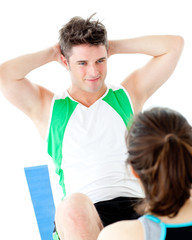 Sticker - Handsome man doing fitness exercises with a woman