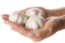 Three Garlic Heads In Woman Hand Isolated