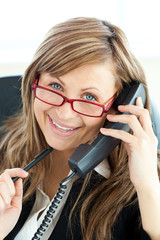 Canvas Print - Ambitious businesswoman talking on phone smiling at the camera