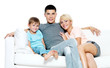 © Valua Vitaly - Beautiful happy young family with kid on sofa. Isolated