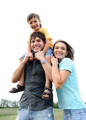 Wall Mural - Happy beautiful young family posing outdoors