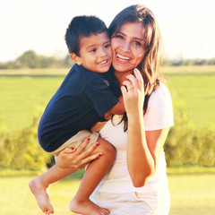 Mother holding toddler child laughing