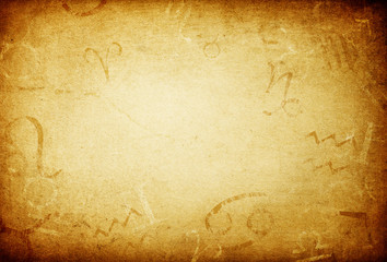 texture of old paper with zodiac signs, abstract astrology theme