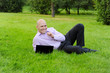 © Valeriy Lebedev - man with laptop lying on green grass