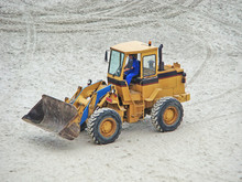 An Excavator Truck Parked On The Sand