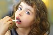© lunamarina - brunette little girl eating playing plastic spoon