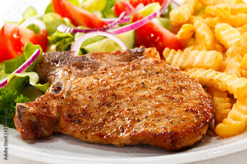 Fotografía Fried pork chop with chips and vegetables