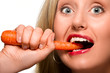 Woman biting carrot