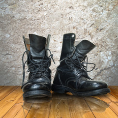 old black boot on wood floor