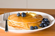 blueberry pancakes on a plate with fork