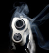 Smoking barrel of a semi-automatic pistol on a black background