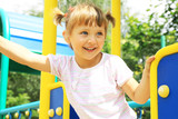 Fototapeta  - A smiling girl on the playground
