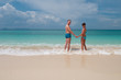 © Iosif Yurlov - Young couple standing on a sandy tropical beach