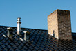 Steel roof with ventilation pipes, flue terminal and chimney