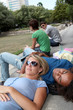 © goodluz - Students resting in  park during summer