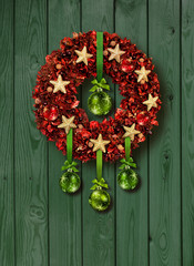 Red Christmas garland on green door