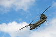 military cargo helicopter in a steep flight maneuver