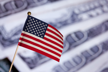 American toy flag over US dollars banknotes.