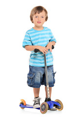 Young boy riding a scooter isolated on white background