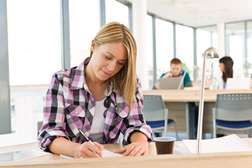 Wall Mural - High school - Thoughtful female student in classroom