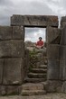 A Young Man Meditates In Ancient Incan Ruins Outside Cuzco,Peru