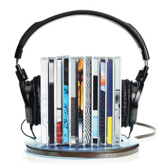 Headphones on stack of CDs and a reel tape